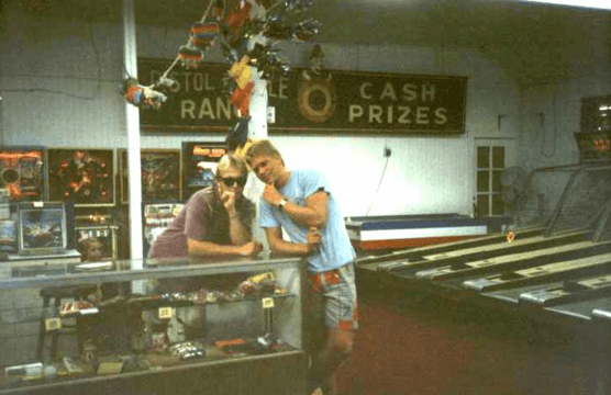 Two friends at an arcade with cash prizes.